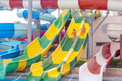 Preview: Boy And Girl Ride With A Water Slide In The Water Park, Concept Of Summer Holidays And Vacations