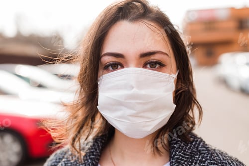 Preview: Young Girl In A Medical Mask On Her Face On The Street