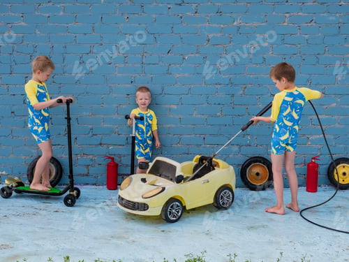 Preview: Funny Children In Boys' Bathing Suits Posing In Front Of Camera With High-Pressure Car Wash And Toy