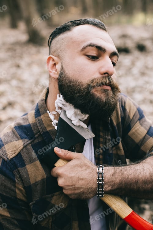 Preview: Bearded Man Shaving With An Ax