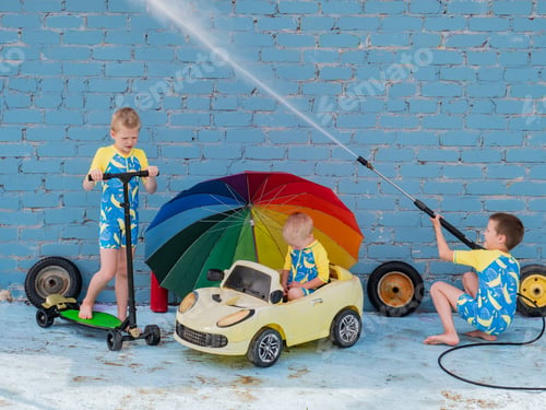Preview: Funny Children In Boys' Bathing Suits Posing In Front Of Camera With High-Pressure Car Wash And Toy
