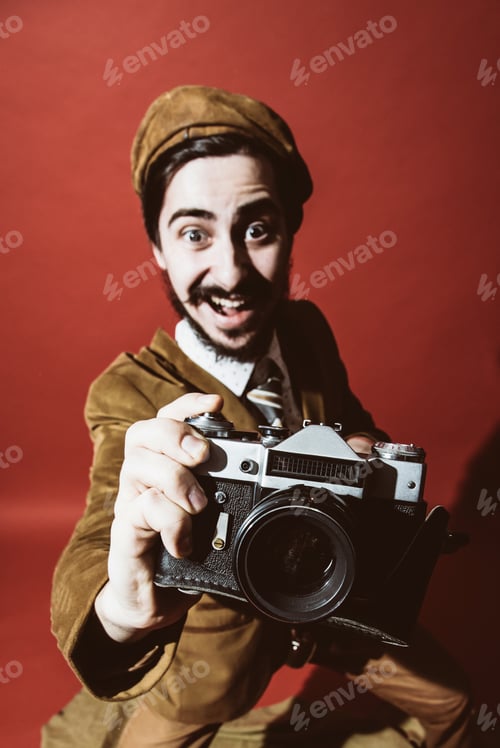 Preview: Very Positive Photographer Posing In Studio With Camera