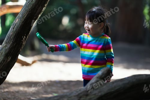 Preview: Young Girl Holding A Magnifier And Looking Up In The Summer Forest Morning