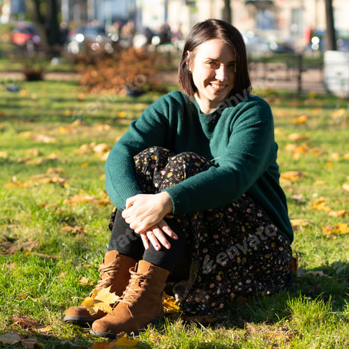 Preview: Young Beautiful Girl Sitting On The Ground In Autumn