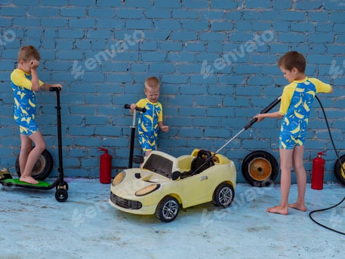 Preview: Funny Children In Boys' Bathing Suits Posing In Front Of Camera With High-Pressure Car Wash And Toy