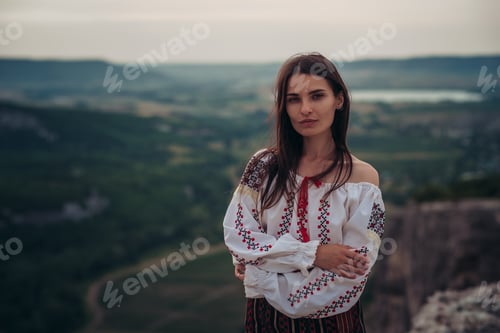 Preview: Attractive Woman In Traditional Romanian Costume On Mountain Green Blurred Background. Outdoor