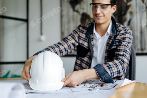 Preview: Engineer With Hard Hat In His Hands, Working In The Office