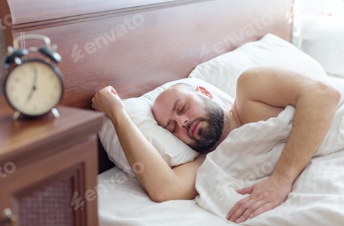Preview: A Young Man With A Beard Wakes Up Early In The Morning, The Concept Of Healthy Sleep, A Noisy