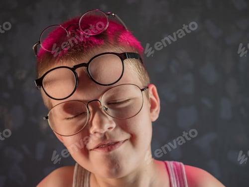 Preview: Photo Of Funny Kid With Many Pairs Of Glasses On Face