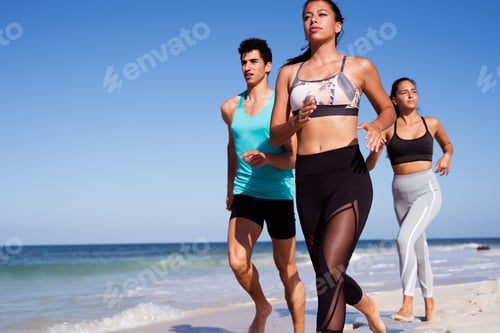 Preview: Close Up Of Runners On The Beach Next To The Shoreline In The Sun
