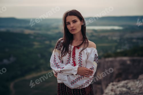 Preview: Attractive Woman In Traditional Romanian Costume On Mountain Green Blurred Background. Outdoor