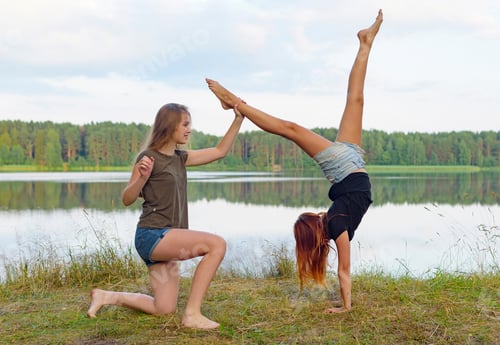 Preview: Two Girls Do Gymnastic Exercises Outdoor In A Picturesque Place By The River And Having Fun