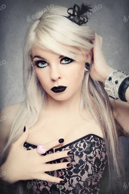 Preview: Beautiful Young Sexy Blond Girl With Stylish Black Make-Up And Fancy Accessories On Noisy Damaged