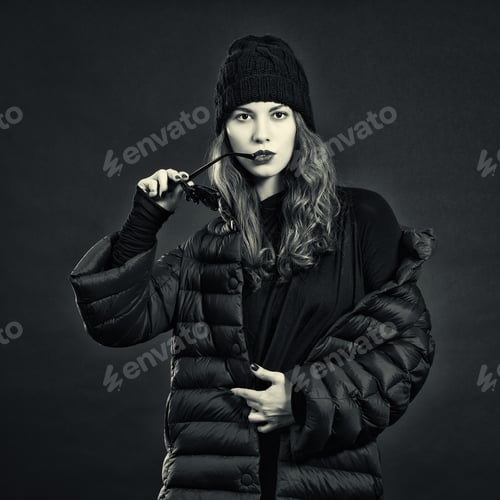 Preview: Stylish Young Woman In A Down Coat And Knit Cap.