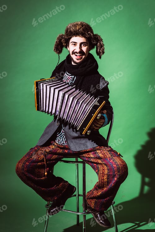 Preview: Positive Man With Accordion Posing In Studio