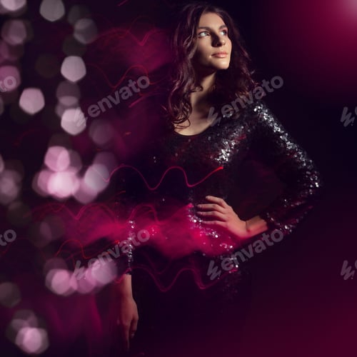 Preview: Beautiful Young Woman In A Shiny Dress On A Background Of Holiday Lights.