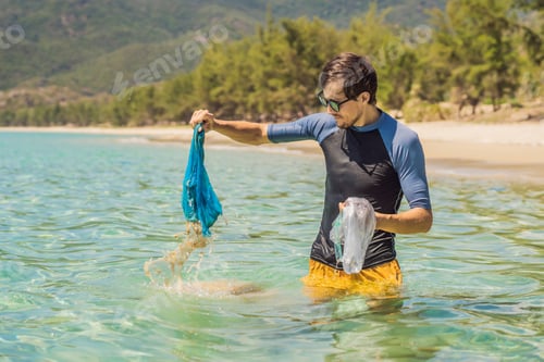 Preview: Man Collects Packages From The Beautiful Turquoise Sea. Paradise Beach Pollution. Problem Of