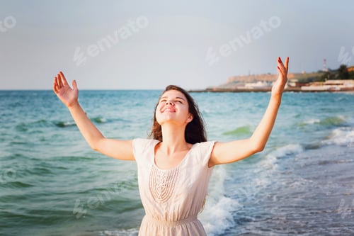Preview: Young Beautiful Caucasian Female Enjoying The Sun On Beach During Sunrise Or Sunset