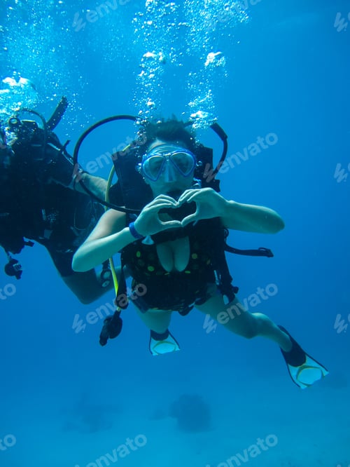 Preview: Underwater Shoot Of A Young Female Diving With Scuba And Showing Love Signal
