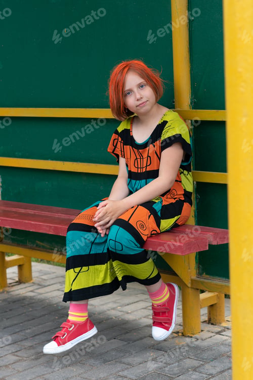 Preview: Small Girl Outside In The City Is In A Colored Dress