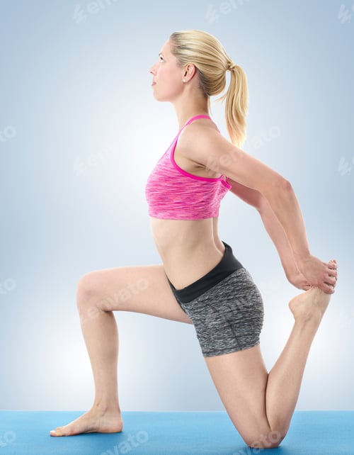 Preview: Young Woman Stretching On Blue Mat