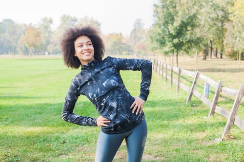 Preview: Sporty Girl Exercise At Park On Green Fields In The Morning. Copy Space For Motivation Quote.