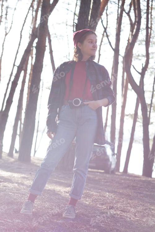 Preview: Beautiful Stylish Girl Holding A Camera In The Forest. Wild Conditions