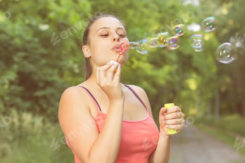 Preview: Young Woman Blowing Bubbles Outdoor. Caucasian Female Relaxing Lifestyle In The Park.