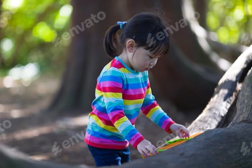 Preview: Young Girl Playing Outdoor Measure-Mate In The Forest Park For Leaning Measurement