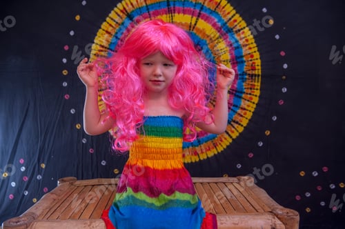 Preview: Happy Cute Caucasian Boy Changed Clothes At Carnival In Dress Of Girl Of Rainbow Color. Pink Doll