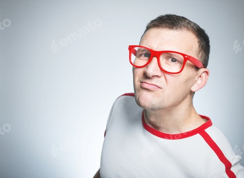 Preview: Close Up Of Frowning Man Looking, Isolated On White. Funny Nerd