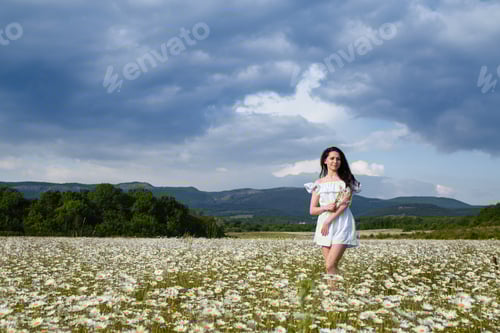 Preview: Beautiful Woman On A Flower Garden Enjoying Her Time Outdoors. Pretty Girl Relaxing Outdoor, Having