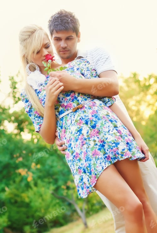 Preview: Lovely Romantic Couple With Flower Embracing