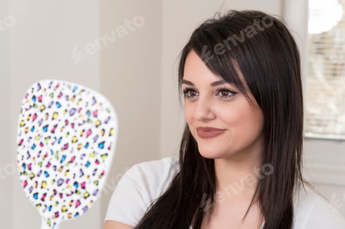 Preview: Close Up Of Beautiful Woman Looking Herself In The Mirror