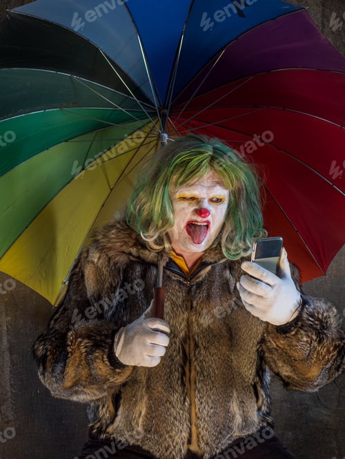 Preview: Crazy Aggressive Clown With Smartphone, Umbrella. Man Hates His Work And In His Free Time Dresses