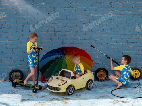 Preview: Funny Children In Boys' Bathing Suits Posing In Front Of Camera With High-Pressure Car Wash And Toy