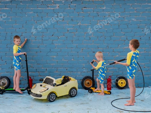 Preview: Funny Children In Boys' Bathing Suits Posing In Front Of Camera With High-Pressure Car Wash And Toy