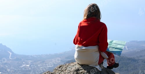 Preview: Girl Hiker Sitting On A Rock And Looking At The Sea