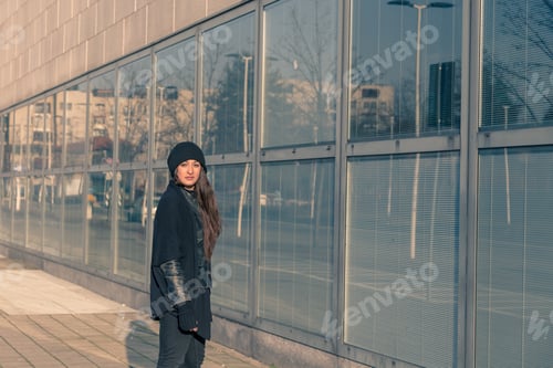 Preview: Beautiful Young Woman With Long Hair Posing In The City Streets