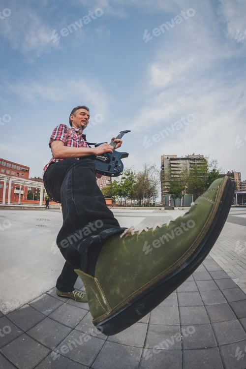 Preview: Man In Short Sleeve Shirt Playing Electric Guitar In The Street