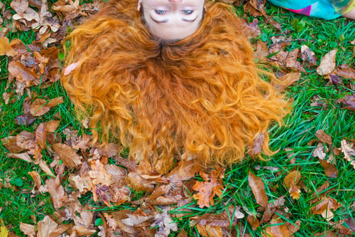 Preview: Woman With Beautiful Red Hair On The Ground In Autumn