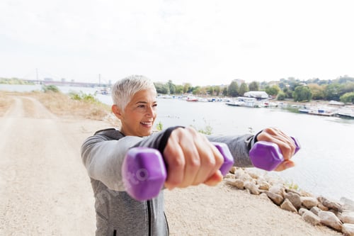 Preview: Fitness Senior Woman In Sports Clothes Working With Weights Outdoor .