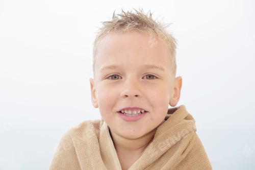Preview: Blond Boy In Towel On The Beach