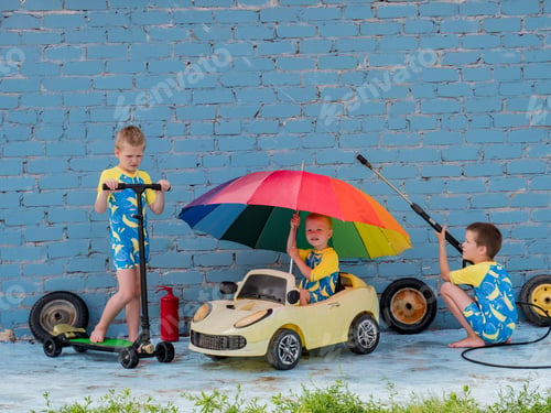 Preview: Funny Children In Boys' Bathing Suits Posing In Front Of Camera With High-Pressure Car Wash And Toy