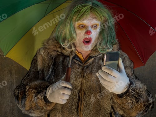 Preview: Crazy Aggressive Clown With Smartphone, Umbrella. Man Hates His Work And In His Free Time Dresses