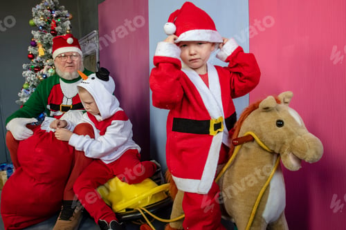 Preview: Family Portrait In Christmas Costumes At Christmas Tree On Eve Of Holiday. Children In Anticipation