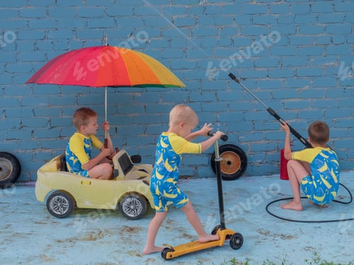 Preview: Funny Children In Boys' Bathing Suits Posing In Front Of Camera With High-Pressure Car Wash And Toy