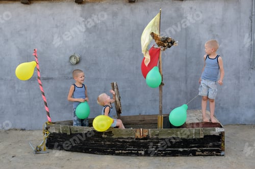 Preview: The Boys Play With Balloons On A Wooden Boat Converted Into A Toy Ship In The Courtyard Of A House