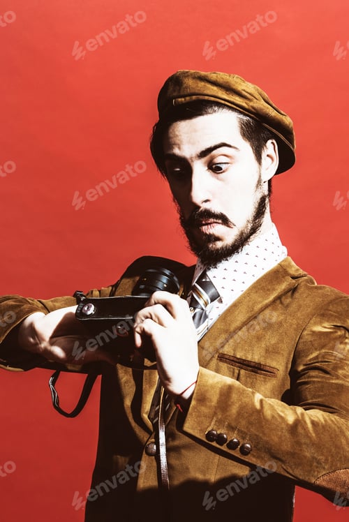 Preview: Very Positive Photographer Posing In Studio With Camera