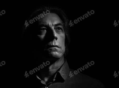 Preview: Portrait Of A Stern Man On A Black Background With Space For Text.